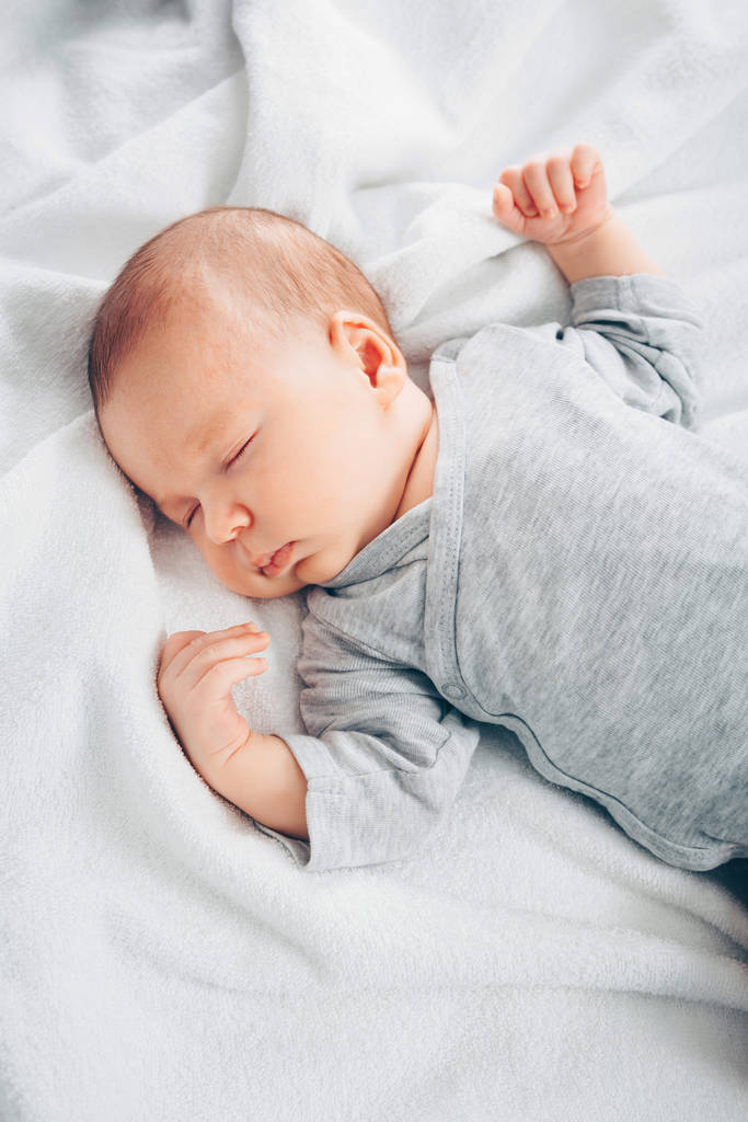 Sleeping newborn baby boy in bed. - Photo, Image
