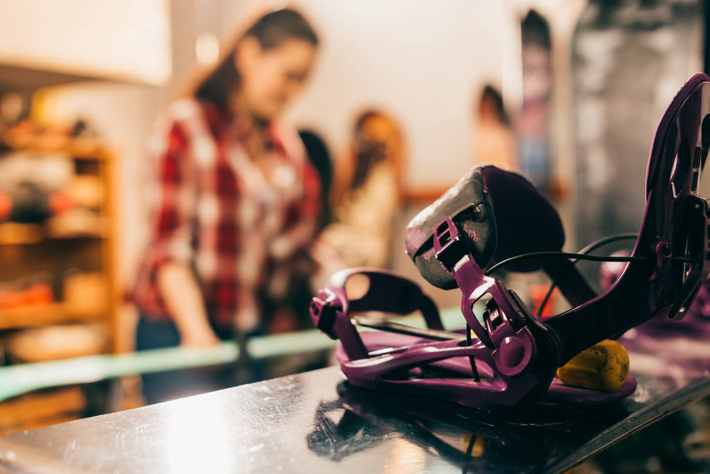 selective focus of snowboard binding and snowboard in repair shop  - Photo, Image