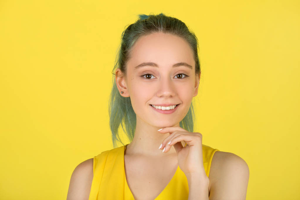 beautiful young woman in a yellow dress on a yellow background - Photo, Image