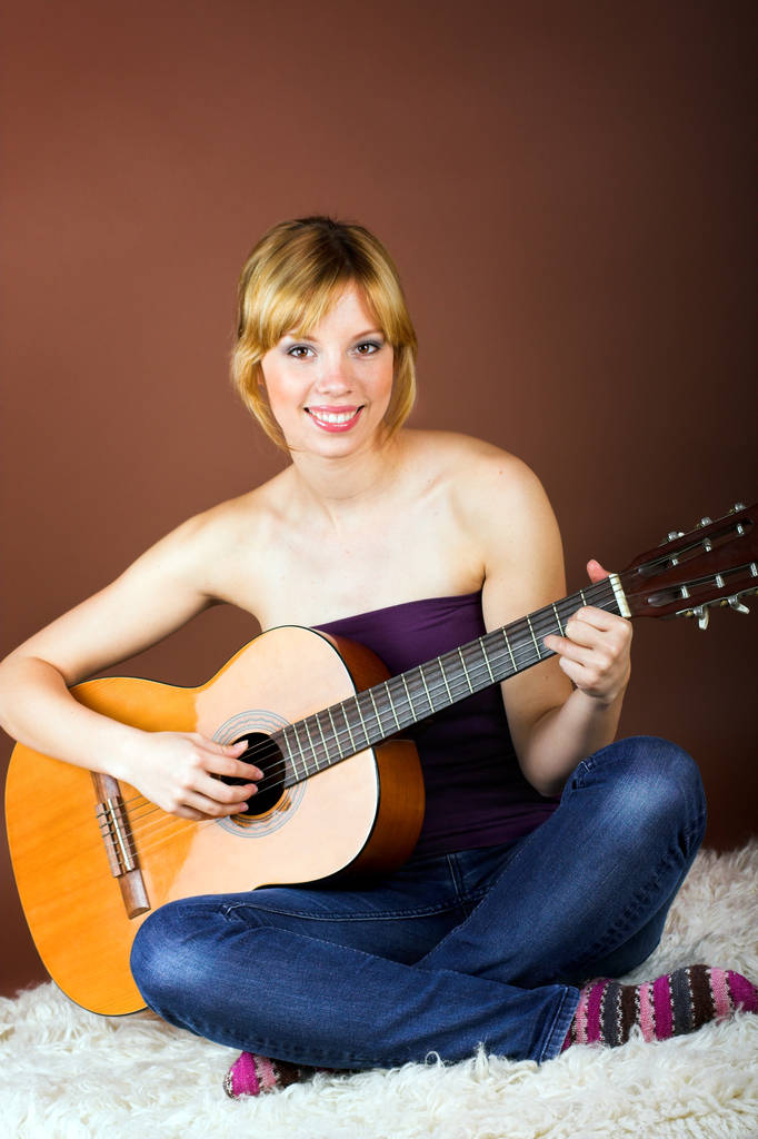 mujer joven sentada en el suelo con guitarra - Foto, imagen