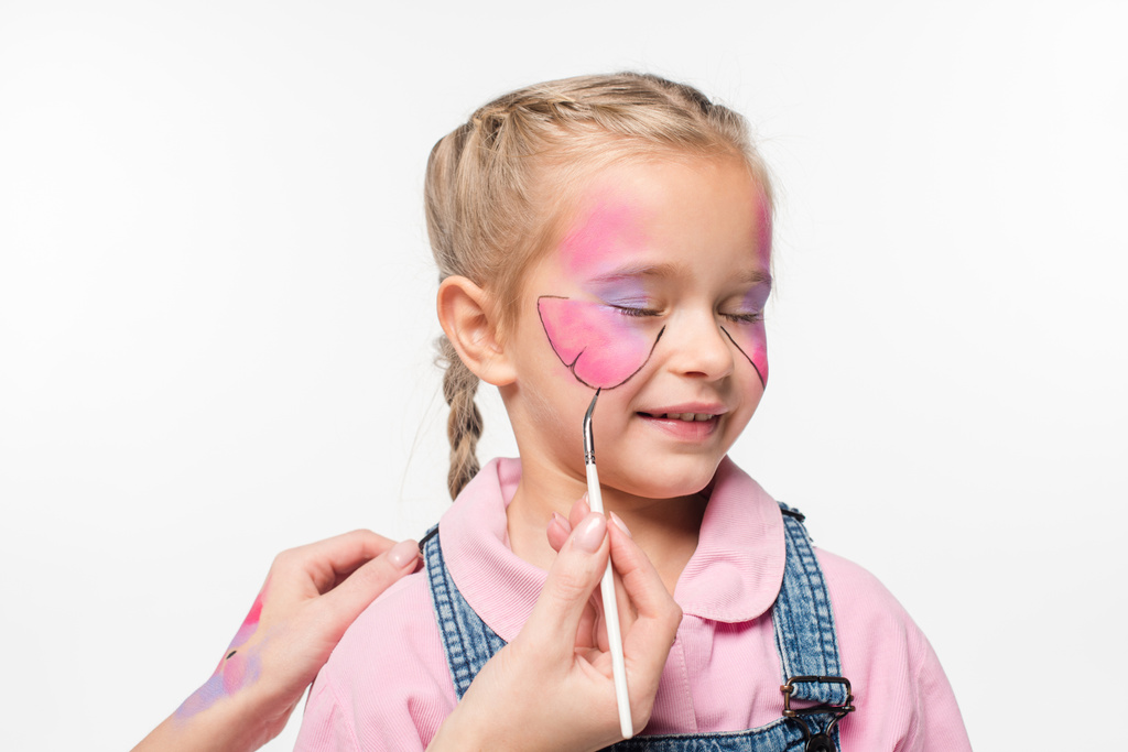 vista cortada de artista pintura borboleta no rosto de criança adorável isolado no branco
 - Foto, Imagem