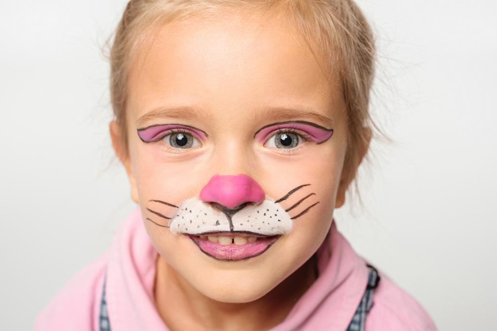 retrato de niño sonriente con pintura de bozal de gato en la cara mirando a la cámara aislada en blanco
 - Foto, imagen