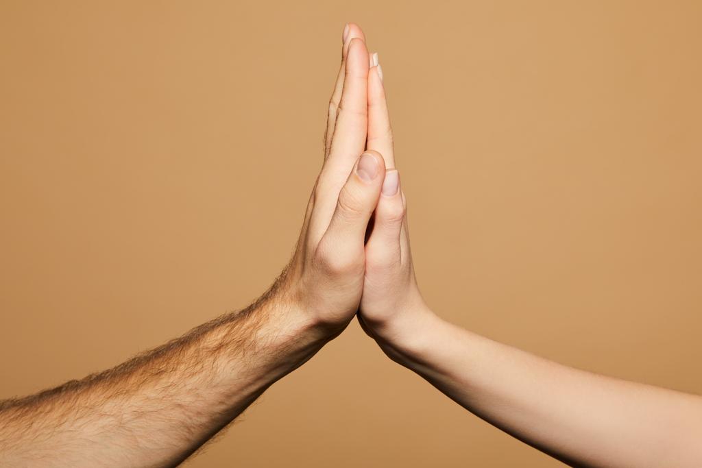 cropped view of man and woman giving high five isolated on beige - Photo, Image