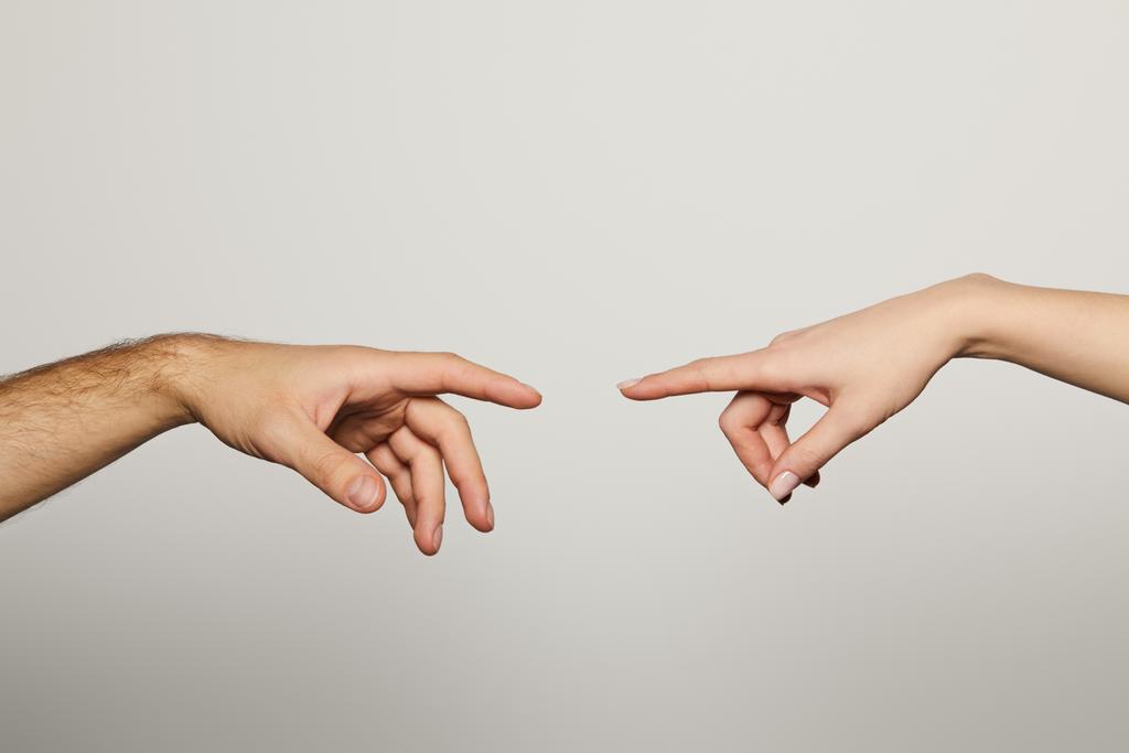 cropped view of man and woman reaching for each other isolated on white - Photo, Image