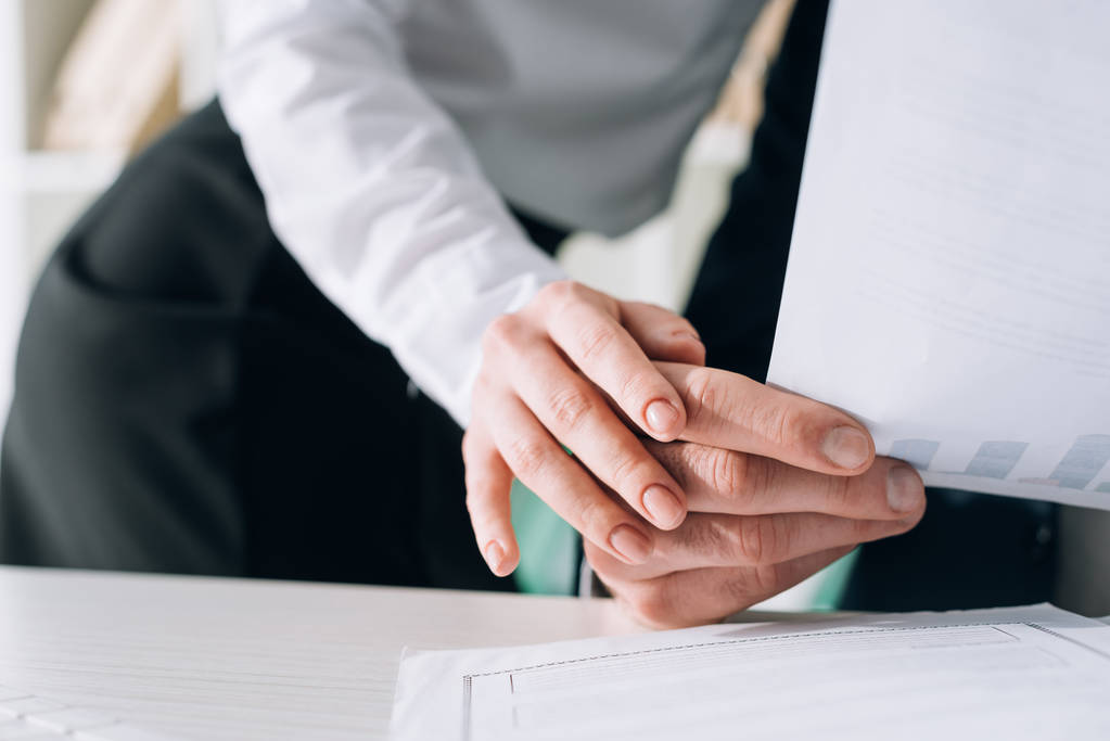 cropped view of secretary touching hand of businessman in office  - Fotoğraf, Görsel
