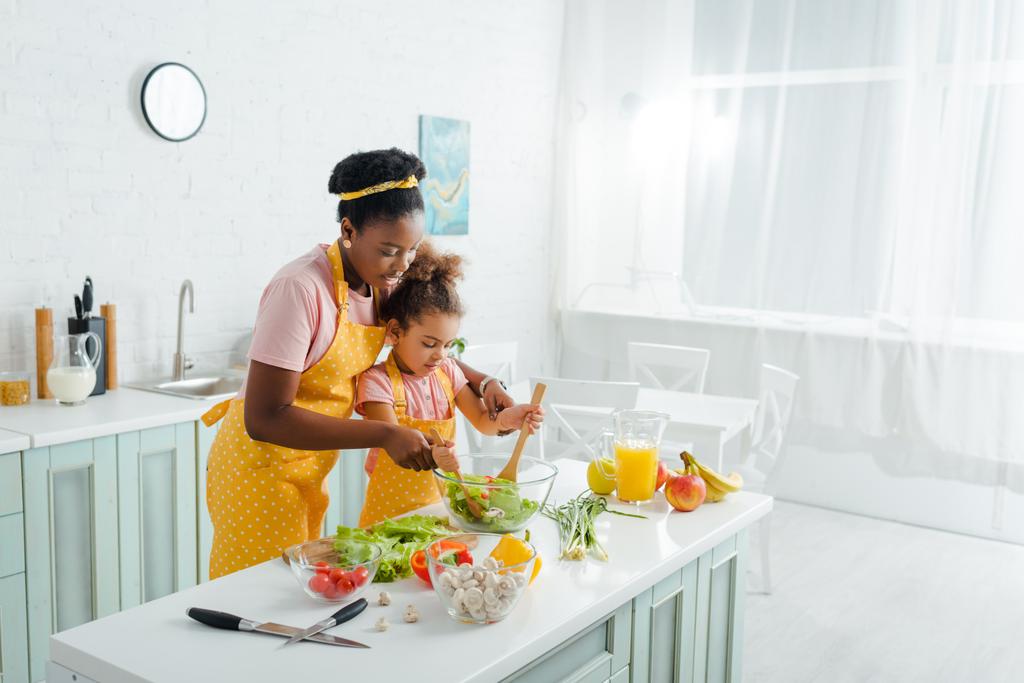 african american mother and child mixing fresh salad  - Photo, Image