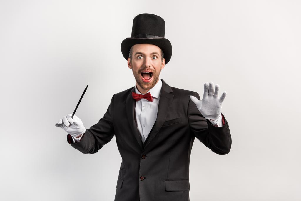 Excited Magician In Suit And Hat Holding Free Stock Photo and Image