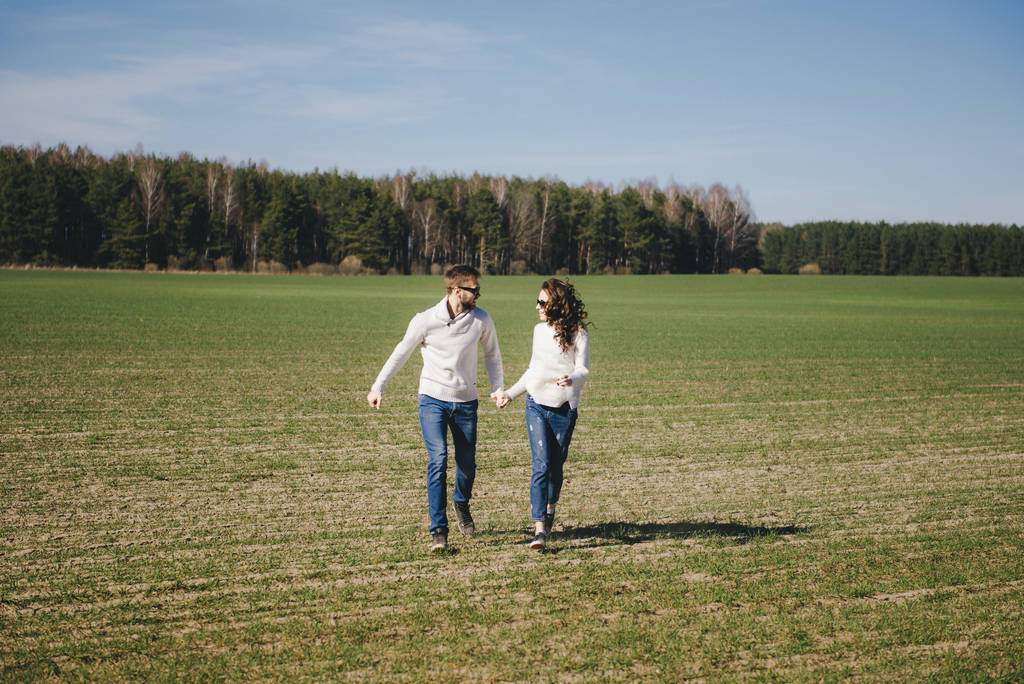 Happy girl and guy running and huggging on the field, love story travel concept, selective focus - Fotografie, Obrázek