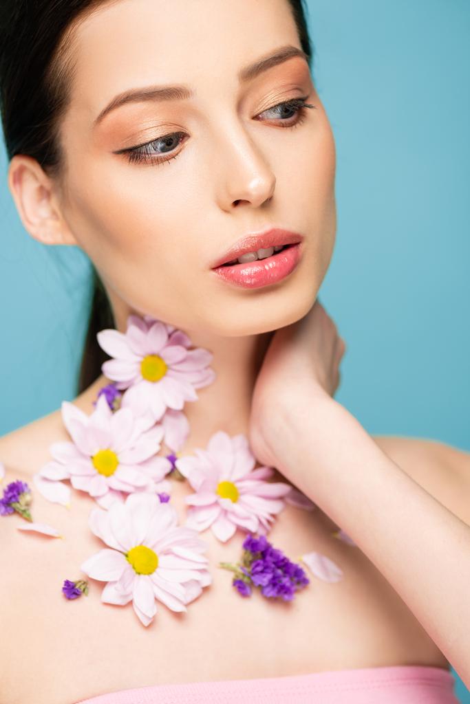 young woman with flowers on neck isolated on blue  - Photo, Image