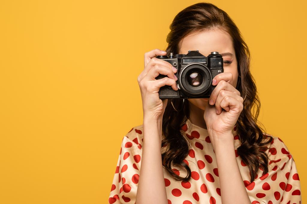 giovane donna che scatta foto su fotocamera digitale isolata su giallo
 - Foto, immagini