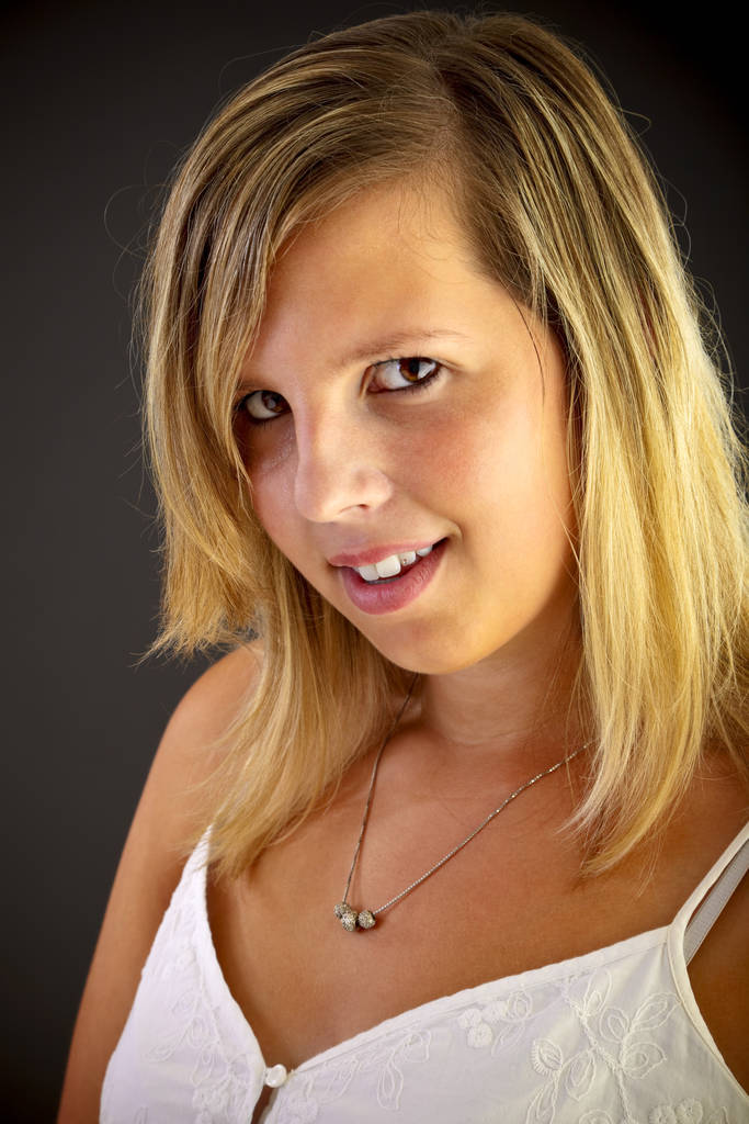 Young blond woman on black background, studio shot. Adobe RGB - 写真・画像