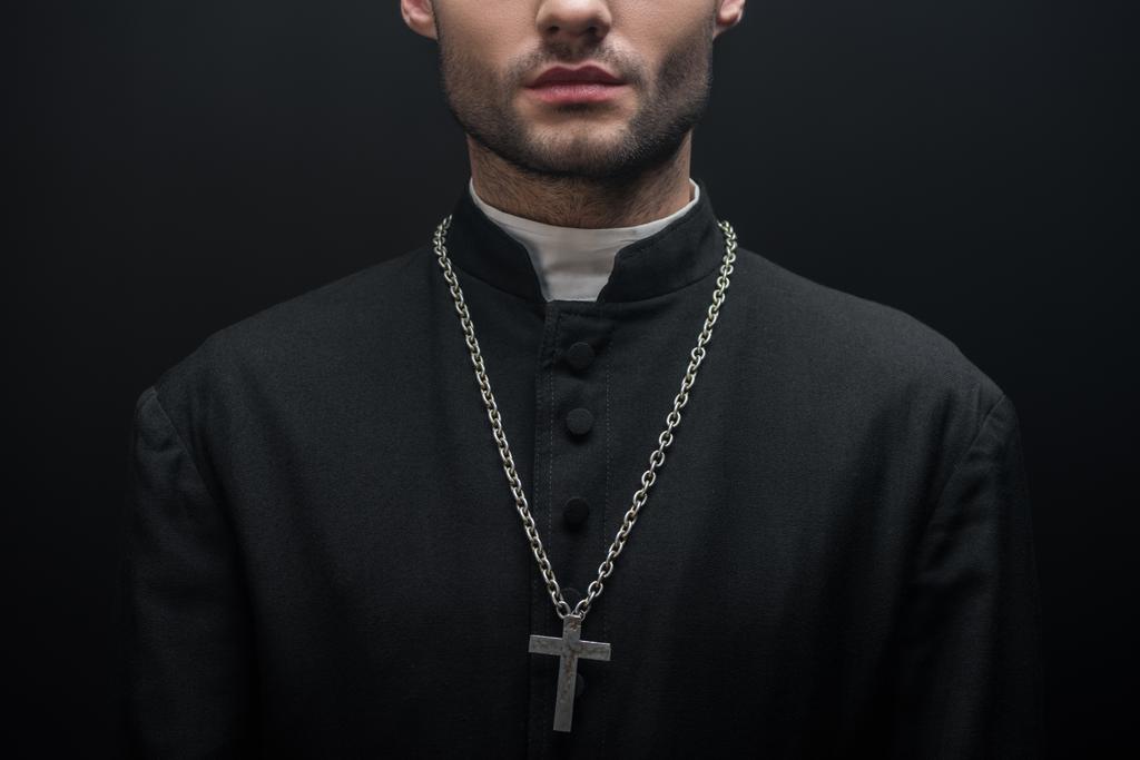 partial view of catholic priest with silver cross on necklace isolated on black - Photo, Image
