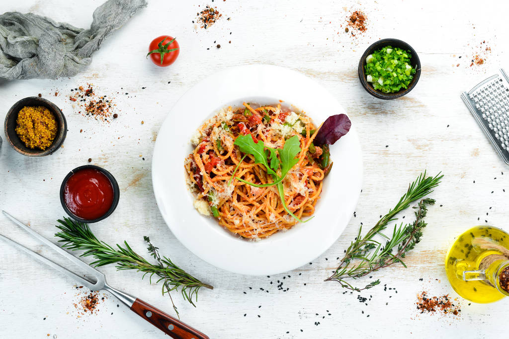Pasta with tomatoes and vegetables. Carbonara. Italian cuisine. Top view. Free space for your text. - Fotoğraf, Görsel
