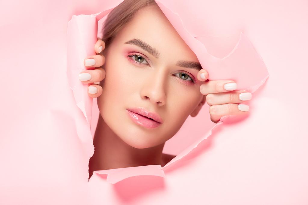 красивая девушка с идеальной кожей в порванной бумаге, изолированная на розовом
 - Фото, изображение
