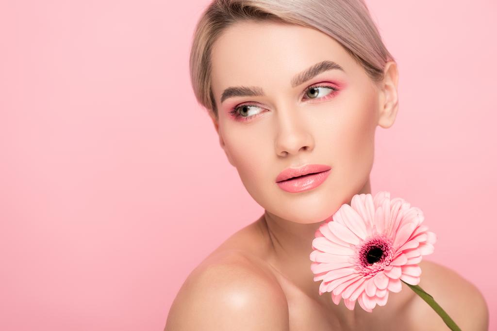 beautiful girl with pink makeup and gerbera flower, isolated on pink - Photo, Image