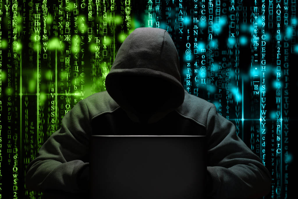 a computer hacker breaks a password while sitting in a dark room at a laptop. Cyber security - Photo, Image