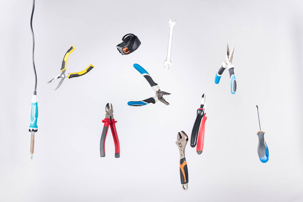 Set of tools levitating in air isolated on grey - Photo, Image