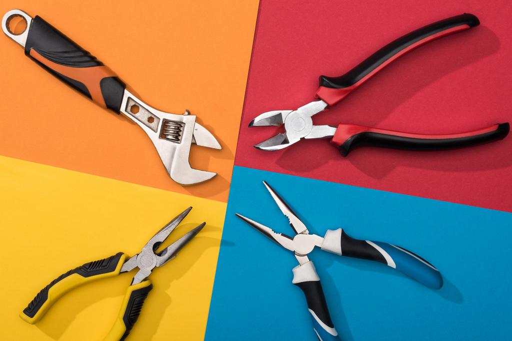 Top view of wrench and pliers on colorful background - Photo, Image