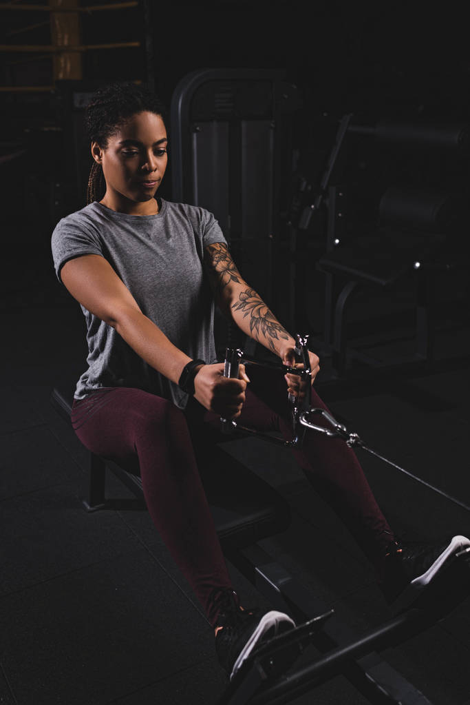 athletic african american sportswoman with tattoo exercising in gym  - Photo, Image