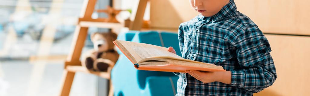 plano panorámico de lindo niño leyendo libro
  - Foto, Imagen