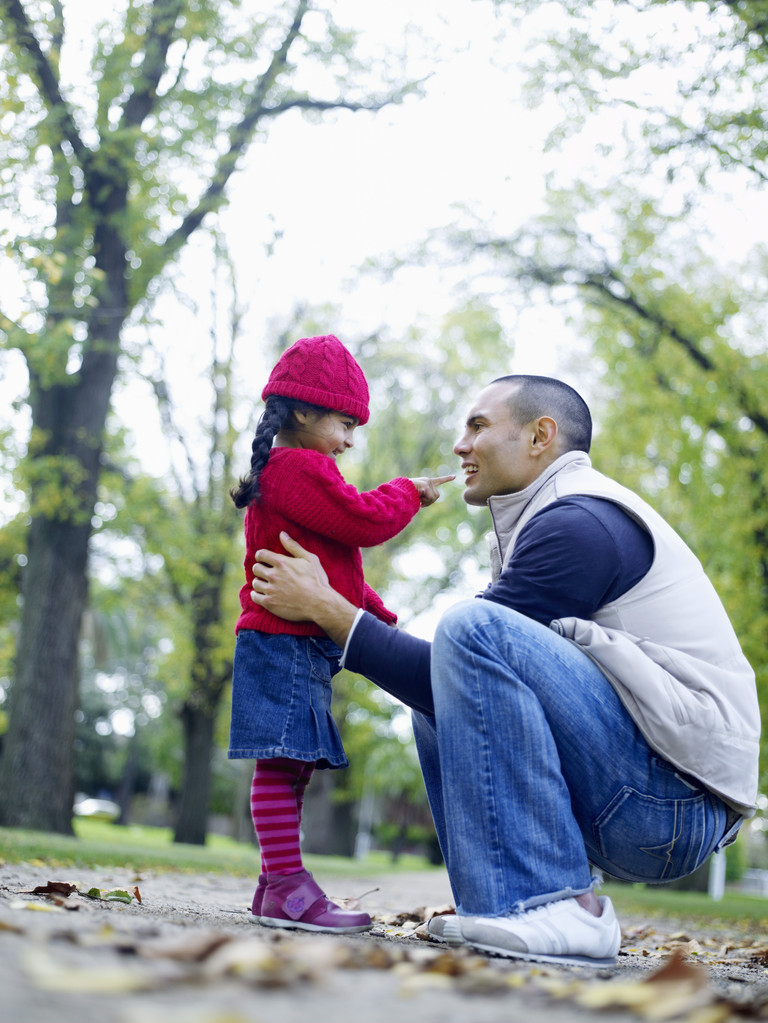 Girl playing with father in park - Photo, Image
