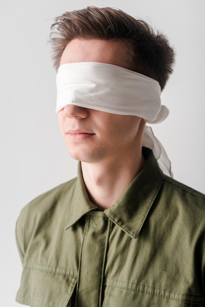 blindfolded young man isolated on white, human rights concept  - Photo, Image