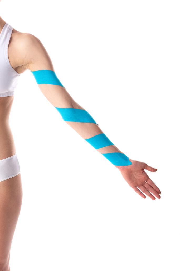 Cropped view of kinesiology tapes on hand on young woman isolated on white - Photo, Image