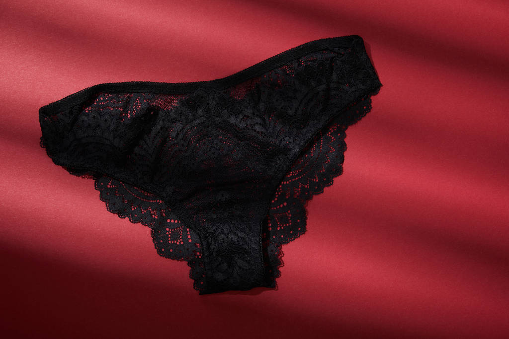 top view of black female panties on red background - Photo, Image