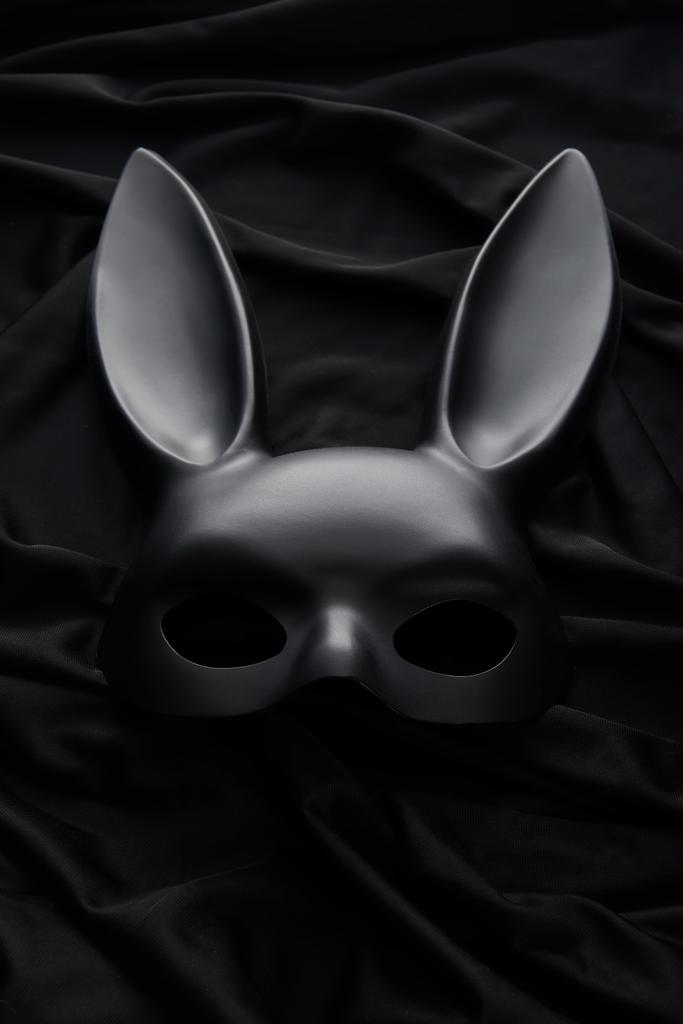vista superior de la máscara de conejo sobre fondo textil negro
 - Foto, imagen
