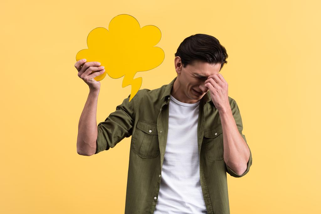 плаче чоловік тримає хмарну бульбашку мовлення, ізольовано на жовтому
 - Фото, зображення