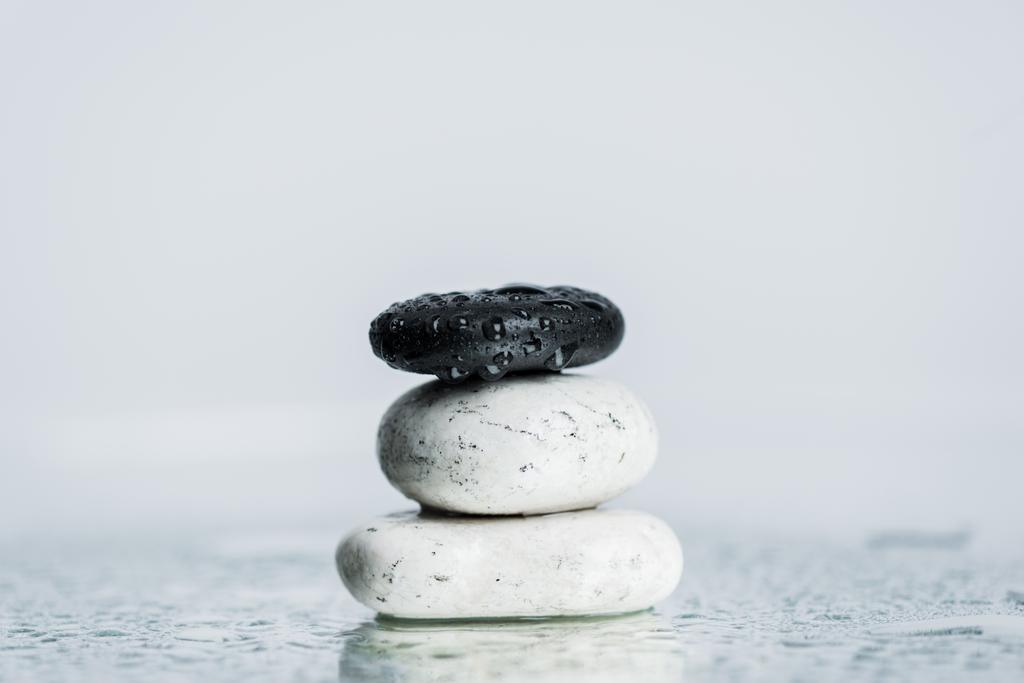 Wet zen stones on glass with water drops isolated on grey  - Photo, Image