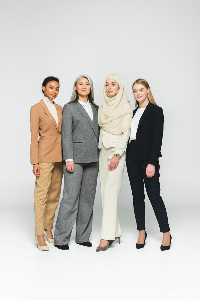 beautiful multicultural businesswomen standing on white  - Photo, Image