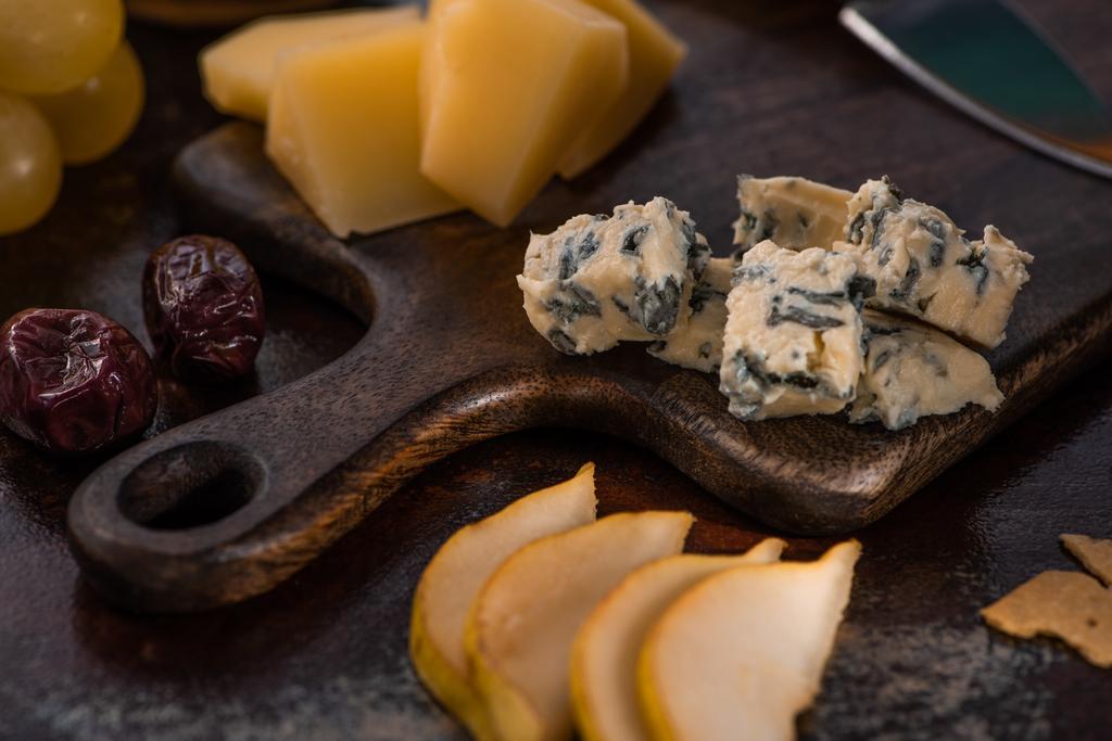 vista de cerca de la bandeja de queso con aceitunas, uvas y pera en rodajas
 - Foto, Imagen