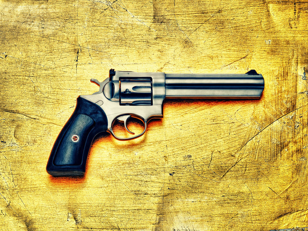 Hand gun against yellow background - Photo, Image