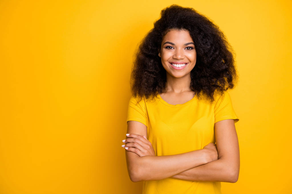 Close-up portrait of her she nice attractive lovely pretty content cheerful cheery wavy-haired girl folded arms isolated over bright vivid shine vibrant yellow color background - 写真・画像