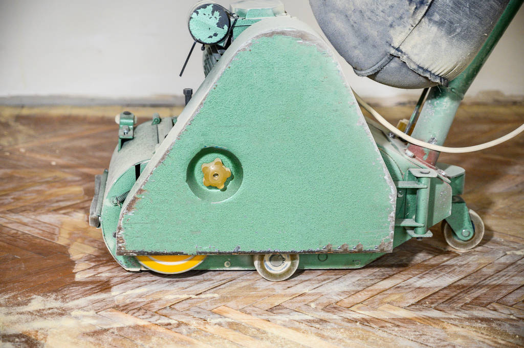 Sanding hardwood floor with the grinding machine. Repair in the apartment. - Photo, Image