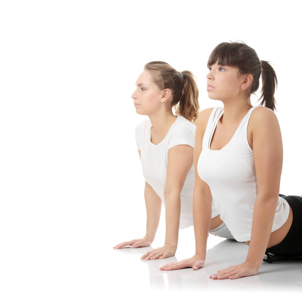 2 překrásné mladé ženské cvičením jóga, izolované - Fotografie, Obrázek