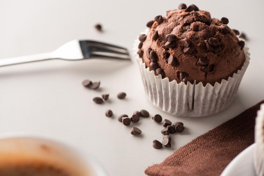 close up view of fresh chocolate muffin near fork - Fotoğraf, Görsel