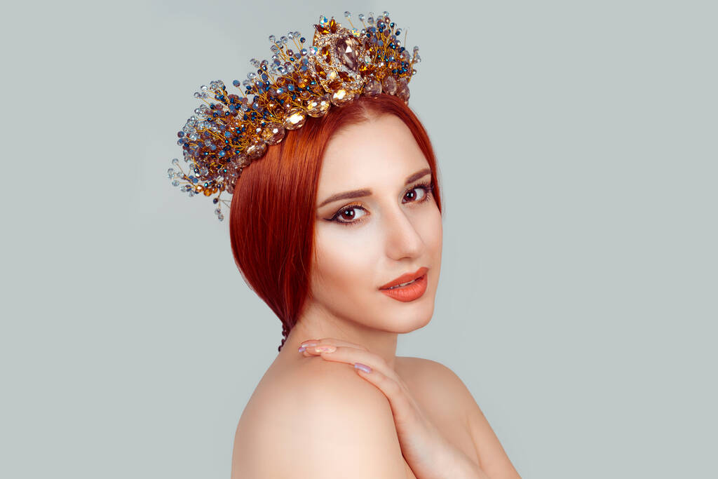Beauty queen posing. Close up portrait of serious, confident woman looking at you camera, proud, sell important crown on head pensive Isolated on light gray background - Photo, Image