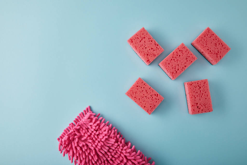 vista superior de artículos para el hogar de color rosa para la limpieza de la casa en azul
 - Foto, imagen