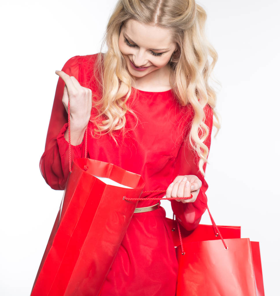 Lány piros csomagokkal - Fotó, kép