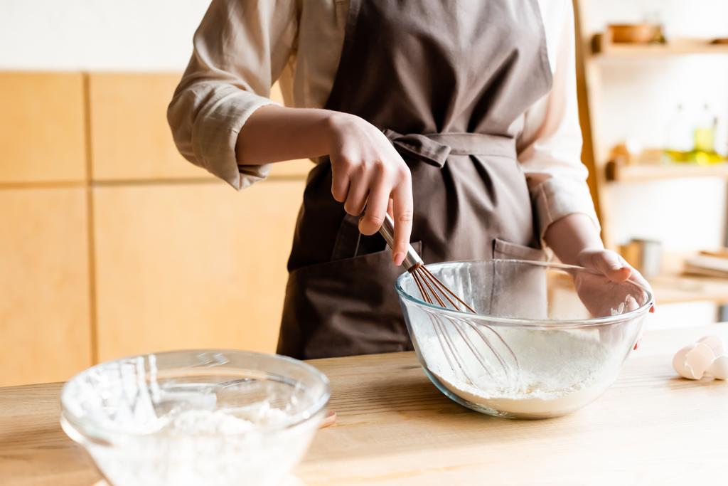 cropped view of girl holding whisk near bowl with flour - Photo, Image