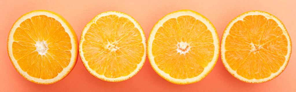 Top view of citrus fruits halves on orange background, panoramic shot - Photo, Image