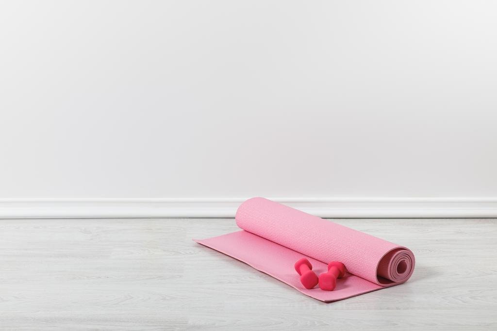 pink fitness mat and dumbbells on floor - Photo, Image