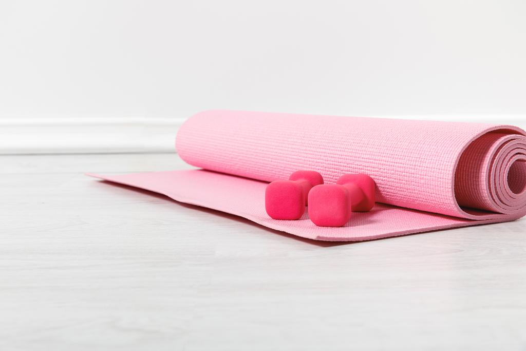 fitness mat and pink dumbbells on floor - Photo, Image