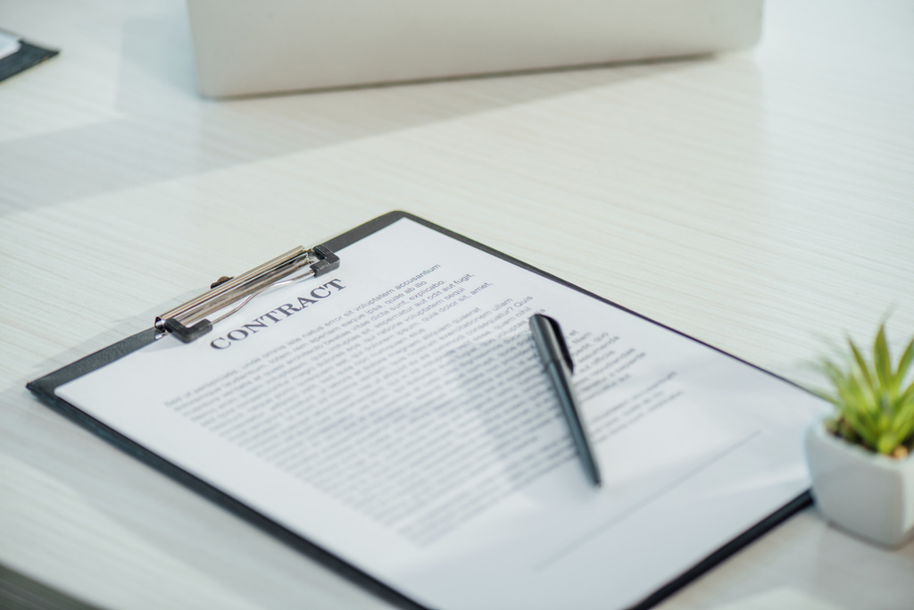 business contract on clipboard with pen on white table  - Photo, Image