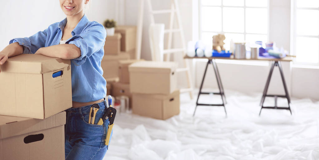 Young woman moving house to new home holding cardboard boxes - Photo, Image