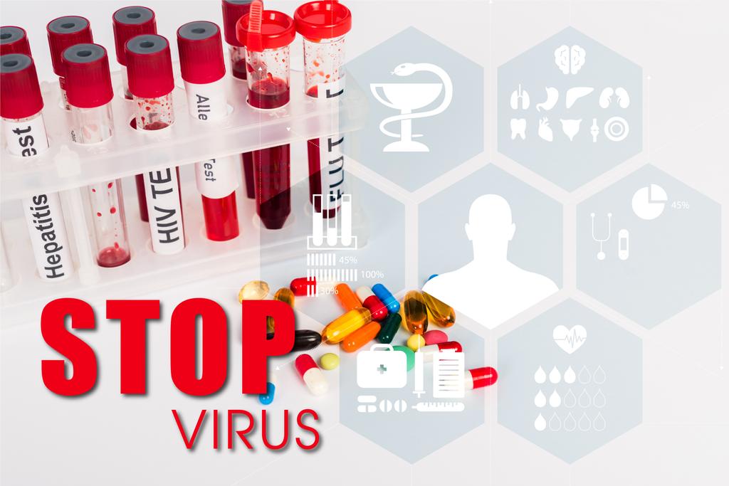 test tubes with blood samples near pills and stop virus lettering on white  - Photo, Image