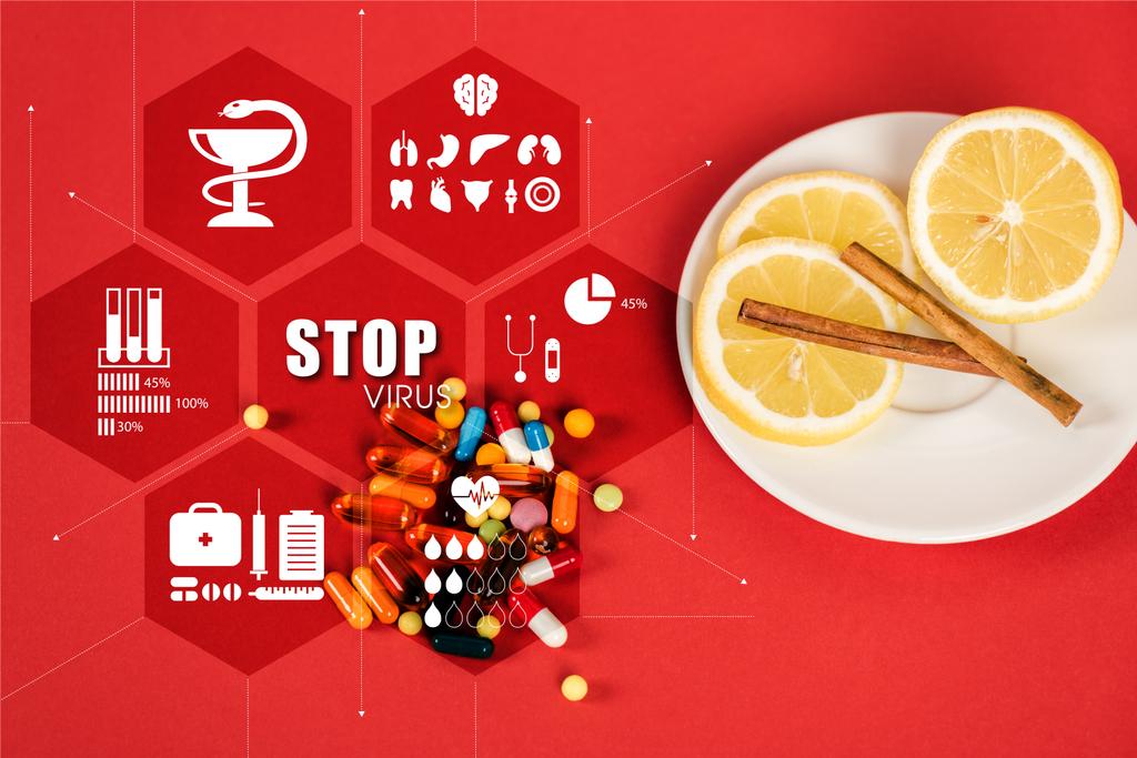 top view of sliced lemons and cinnamon sticks near pills and stop virus lettering on red  - Photo, Image