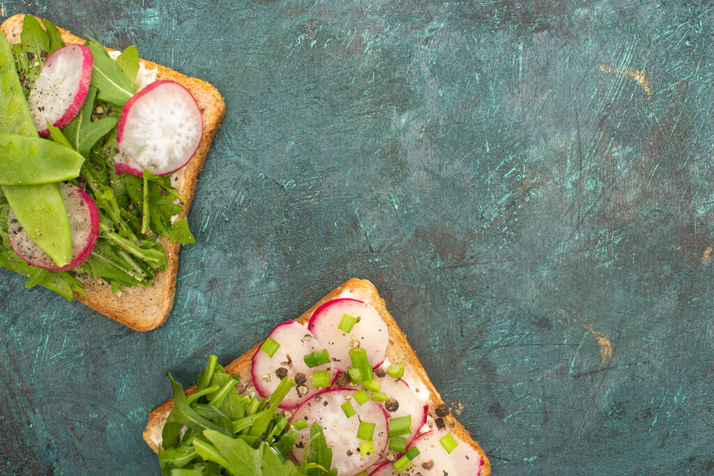 top view of organic radish sandwiches on green stone table - Photo, Image
